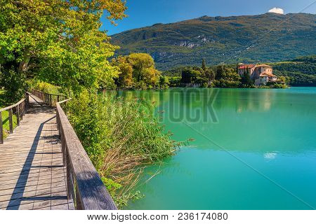 Majestic Wooden Bridge, Wonderful Toblino Lake With High Mountains And Medieval Castle Toblino In Ba