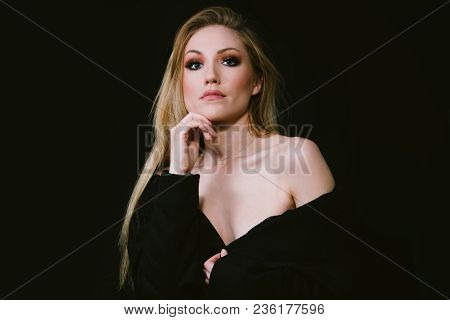 Beautiful Young Self Confident Diva Lady With Long Blonde Hair In Long Coat Posing In Studio, Dark B