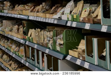 Blurred Nuts Section At Retail Store In Europe.  Aisle In Local Supermarket, Defocused Background.