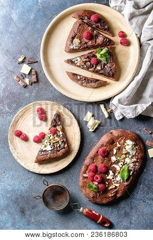 Whole And Slised Homemade Dessert Chocolate Pizza With Different Chocolates, Raspberries And Mint Se