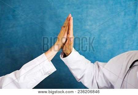 Two Doctors Doing High Five Gesture Close Up
