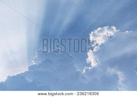 Sun Light Beams Escaping Behiind Large White Puffy Clouds In Vietnam In Southeast Asia.