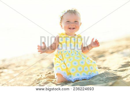 Lovely Little Girl On The Beach With An Umbrella.