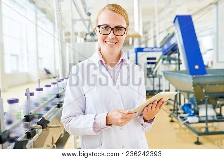 Attractive Young Inspector Wearing White Coat Looking At Camera With Charming Smile While Standing A