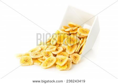 Heap Of Dried Banana Chips Snack In White Bowl Over White Background