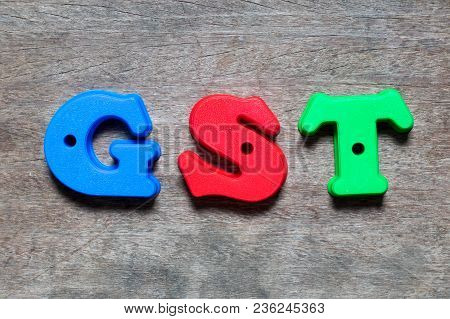 Color Alphabet In Word Gst (abbreviation Of Goods And Services Tax) On Wood Background