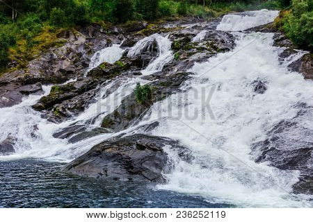 Hellesyltfossen waterfall in the area Geirangerfjord in village Hellesylt