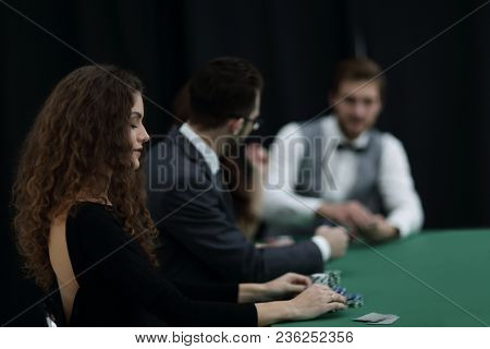 luckiest woman on the background of the players in the casino.