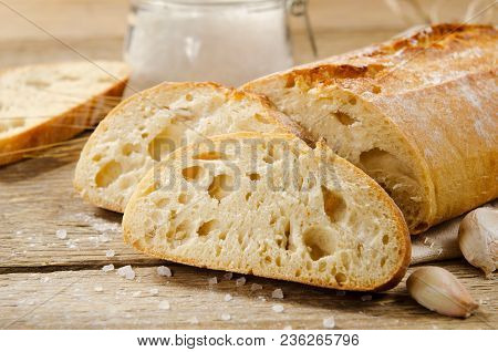 Ciabatta Bread. Slices Of Ciabatta With Garlic, Salt On A Wooden Table On Linen Cloth. Rustic Style,