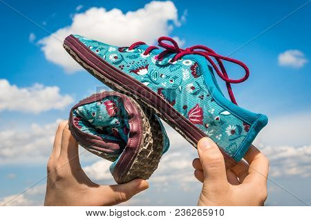 Woman Is Holding Barefoot Shoes With Flexible Sole