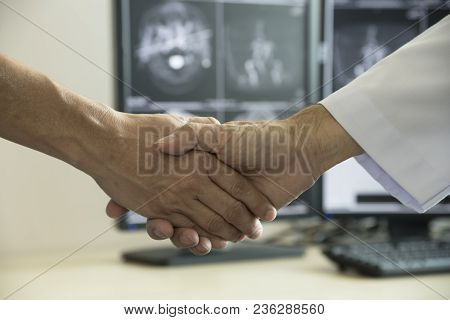 Doctor Shaing A Patient Hand In Medical Office
