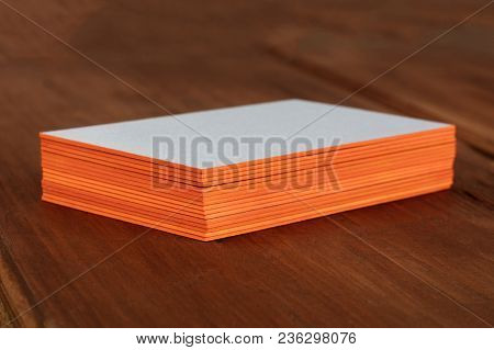 A Stack Of Blank Layered Business Cards With Painted Edges, On A Dark Background, With A Shallow Dep