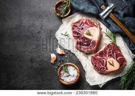 Raw Beef Steak Osso Bucco On Black Stone Slate Background. Marble Meat. Top View With Copy Space.