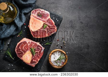 Raw Beef Steak Osso Bucco On Black Stone Slate Background. Marble Meat. Top View With Copy Space.