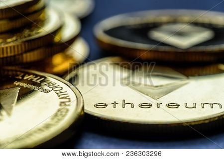 Closeup Golden Virtual Money Ethereum Crypto Currency Coins Stacked On A Dark Background.