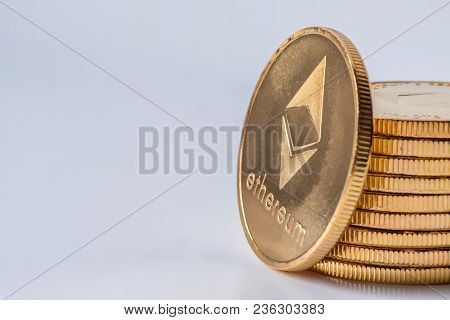 Golden Virtual Money Ethereum Crypto Currency Coins Stacked On Bright Background.