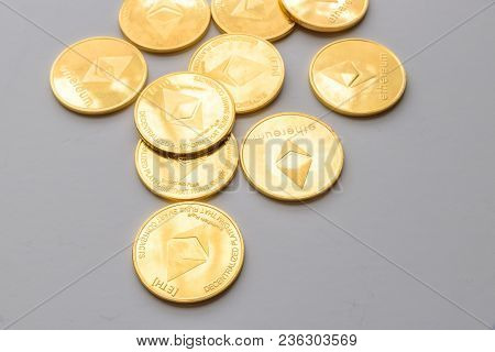 Golden Virtual Money Ethereum Crypto Currency Coins Stacked On Bright Background.