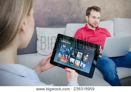 Woman Using Digital Tablet For Watching Movie On Vod Service. Video On Demand Television Internet St