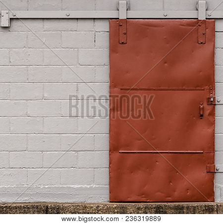 Old Red Sliding Dock Door On Rollers And Rail.