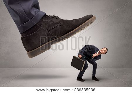 Young businessman illustrated inconsiderable by being trampled