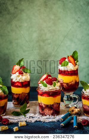 Fruit Cake, Jelly, Custard, Berry And White Cocolate Whipped Cream Individual Trifles, Copy Space Fo