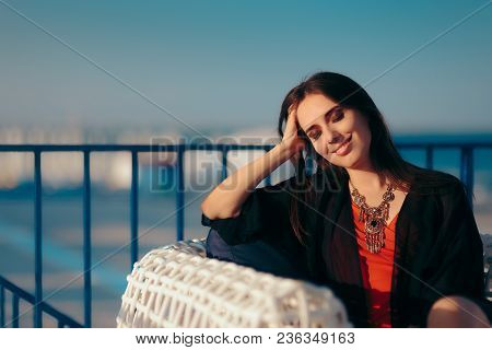 Happy Woman Sitting On A Chair Relaxing On Summer Vacation