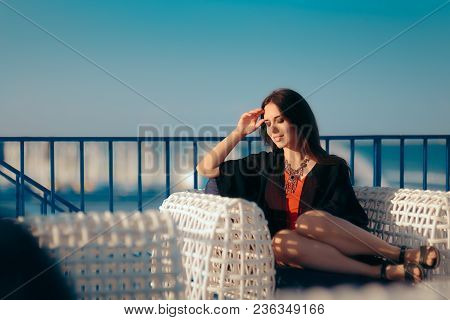 Happy Woman Sitting On A Chair Relaxing On Summer Vacation