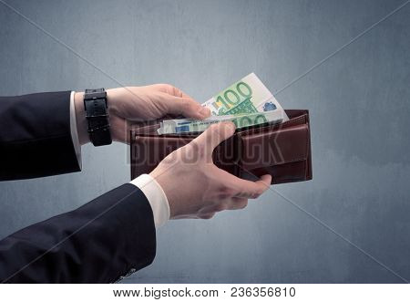 Businessman's hand in suit takes out eruo from his wallet