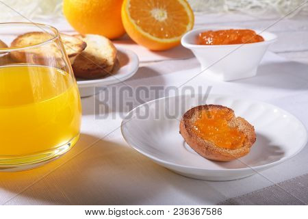 Morning Breakfast Set With Orange Jam On Bread Toast And Juice In Glass