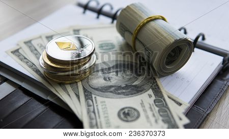Ethereum Crypto Currency On Top Of 100 Dollar Biils On Notepad. Profit From Mining Crypto Currencies