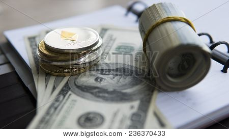 Ethereum Crypto Currency On Top Of 100 Dollar Biils On Notepad. Profit From Mining Crypto Currencies