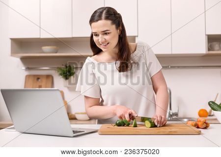 Dialog With Auditoria. Pretty Female Blogger Creating Video While Slicing Vegetable