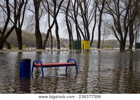 The River Spilled From Its Banks. In Water - Beach, Benches, Cabanas, A Road. It Happens Every Sprin