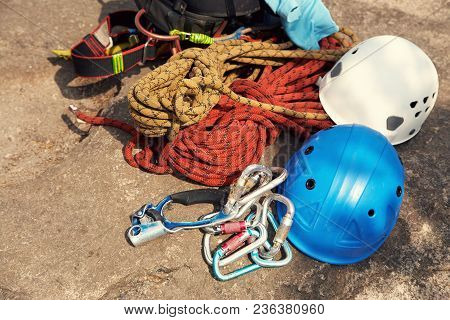 A Set Of Sports Equipment For Climbing And Mountaineering. Ropes And Carabiners Lying On A Rock