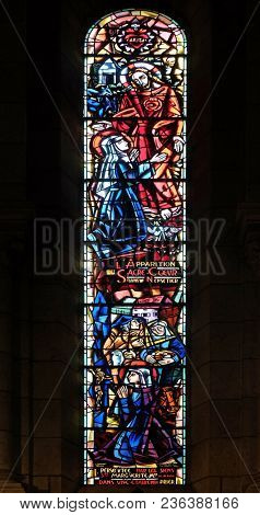 PARIS, FRANCE - JANUARY 08, 2018: Scenes from the life of Saint Margaret Mary Alacoque, stained glass window in Basilica of the Sacre Coeur, dedicated to the Sacred Heart of Jesus in Paris, France.