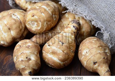 Jerusalem Artichokes Or Sunchokes On Wooden Background