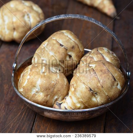 Jerusalem Artichokes Or Sunchokes On Wooden Background