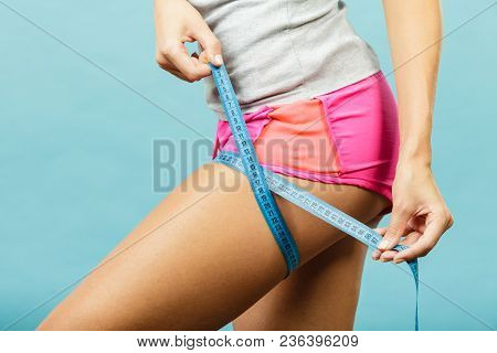Time For Diet Slimming Weight Loss. Fitness Woman Fit Girl In Sportswear With Measure Tape Measuring