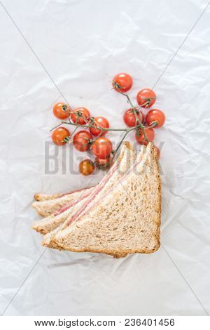 Wholemeal bread sandwich topped with Lyon rosette and butter