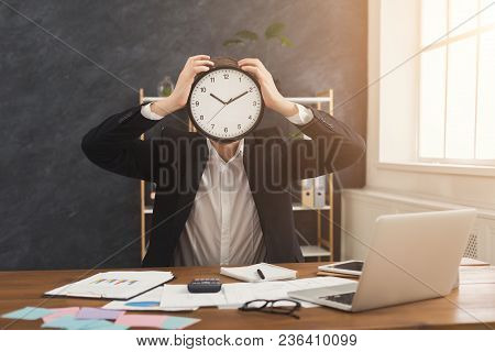 Businessman Covering Face With Clock. Portrait Of Man With Watches At Office. Time Management And Ti