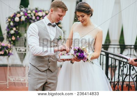 Bride And Groom Exchange Rings At The Wedding