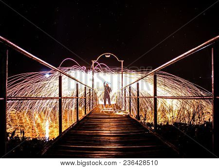Fire Umbrella Made With Lightpainting In A Corridor Under The Sky Full Of Stars.