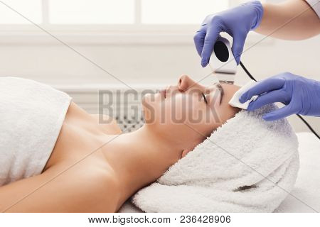 Rejuvenating Facial Treatment. Model Getting Lifting Therapy Massage In A Beauty Spa Salon. Exfoliat