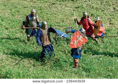 Luh, Russia - August 27, 2016: Reconstruction Of Medieval Battle Of Knights In Armor And Weapons At 