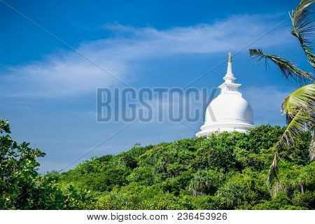 Japanese Peace Stupa located on the top of legendary Rumassala mountain created by God Hanuman dropped here chunk of Himalaya , Unawatuna,  Sri Lanka.