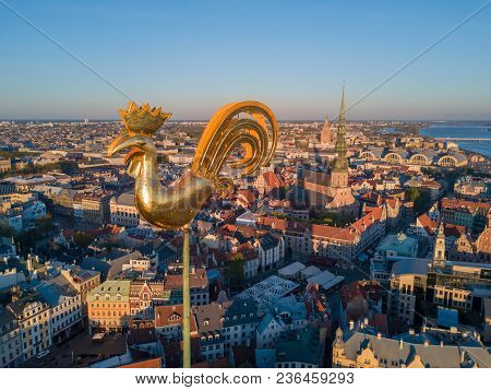 Sunset View Over The Old Town Of Riga - Vecriga With Golden Rooster In The Foreground