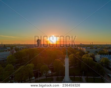Amazing Aerial Sunset View Over Riga City In Latvia. Statue Of Liberty In The Middle Of The City - M