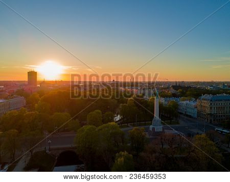 Amazing Aerial Sunset View Over Riga City In Latvia. Statue Of Liberty In The Middle Of The City - M