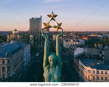 Beautiful Sunset View In Riga By The Statue Of Liberty - Milda.