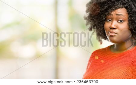 Beautiful african woman having skeptical and dissatisfied look expressing Distrust, skepticism and doubt, outdoor